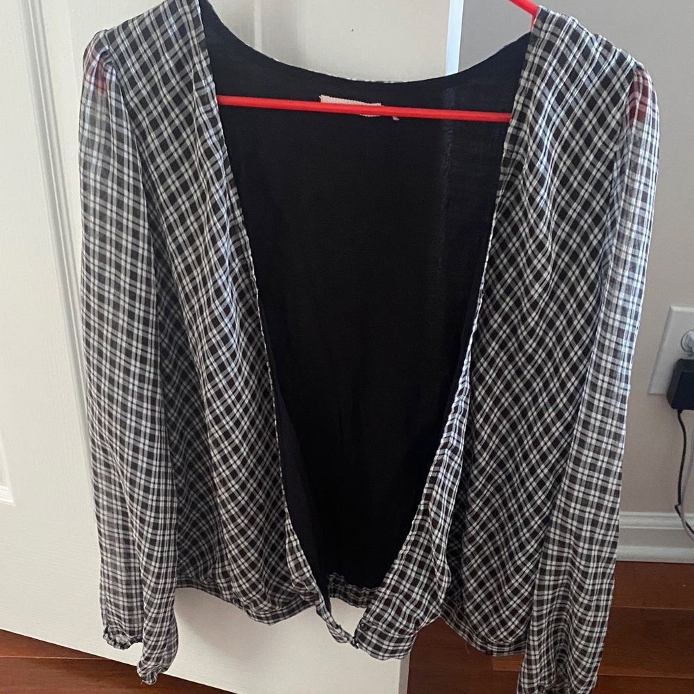 Plaid Black and White Women's Blouse. V neck that buttons at the bottom.